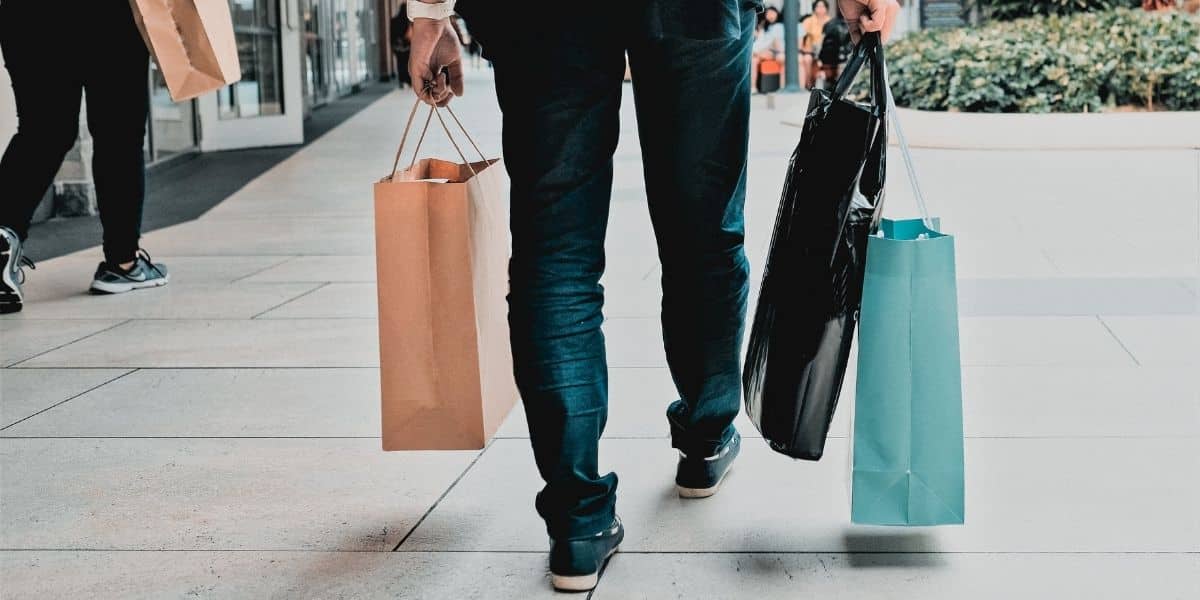 man walking with shopping bags