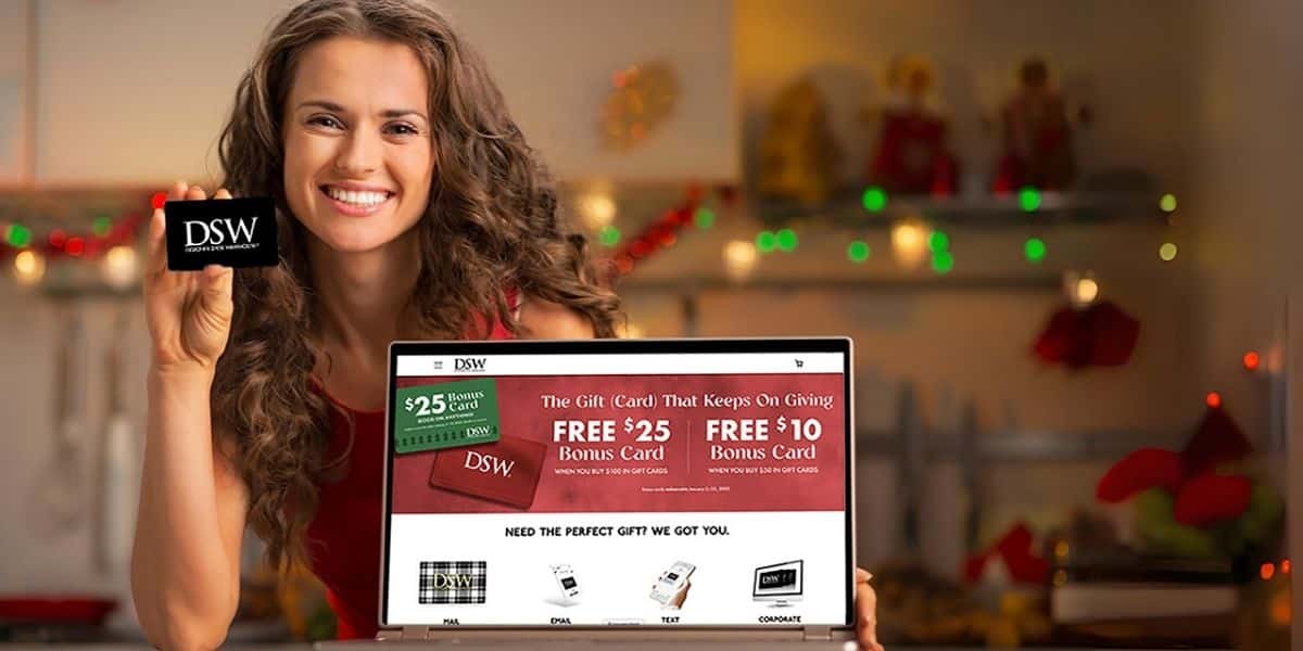 woman holding dsw gift card on dsw promo site