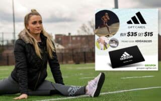 woman in adidas shoes stretching on field