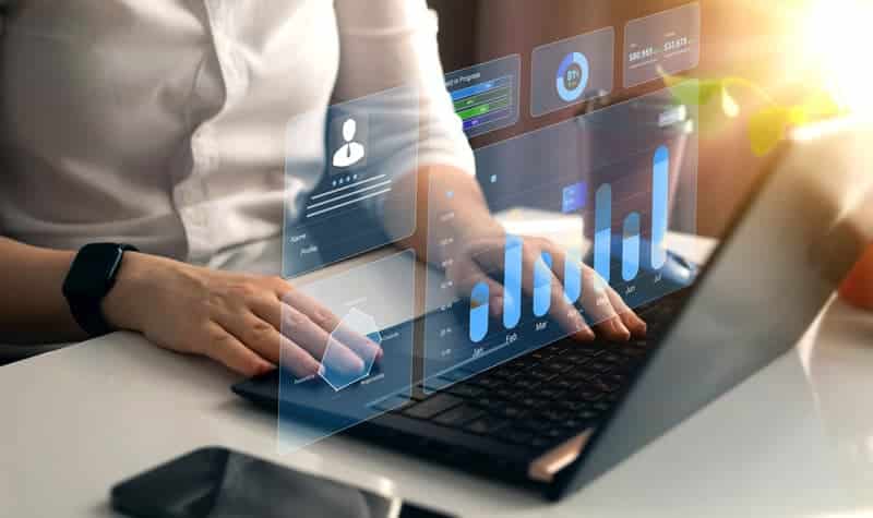 A man manually reviewing a KYB dashboard,.