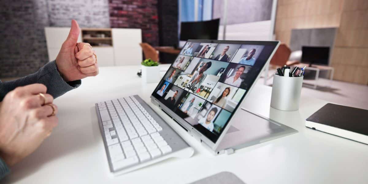 man on a virtual call man on a virtual team call with lap top on a desk