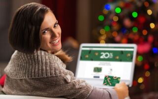 woman looking at computer showing gift cards om sale