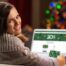 woman looking at computer showing gift cards om sale