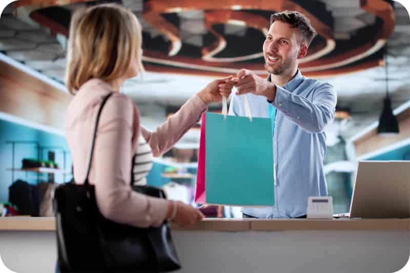 A photo of a retail employee helping a shopper